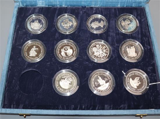 A 70th Birthday Silver Proof Collection, cased (one coin deficient), sundry commemorative coinage and a pair of silver napkin rings